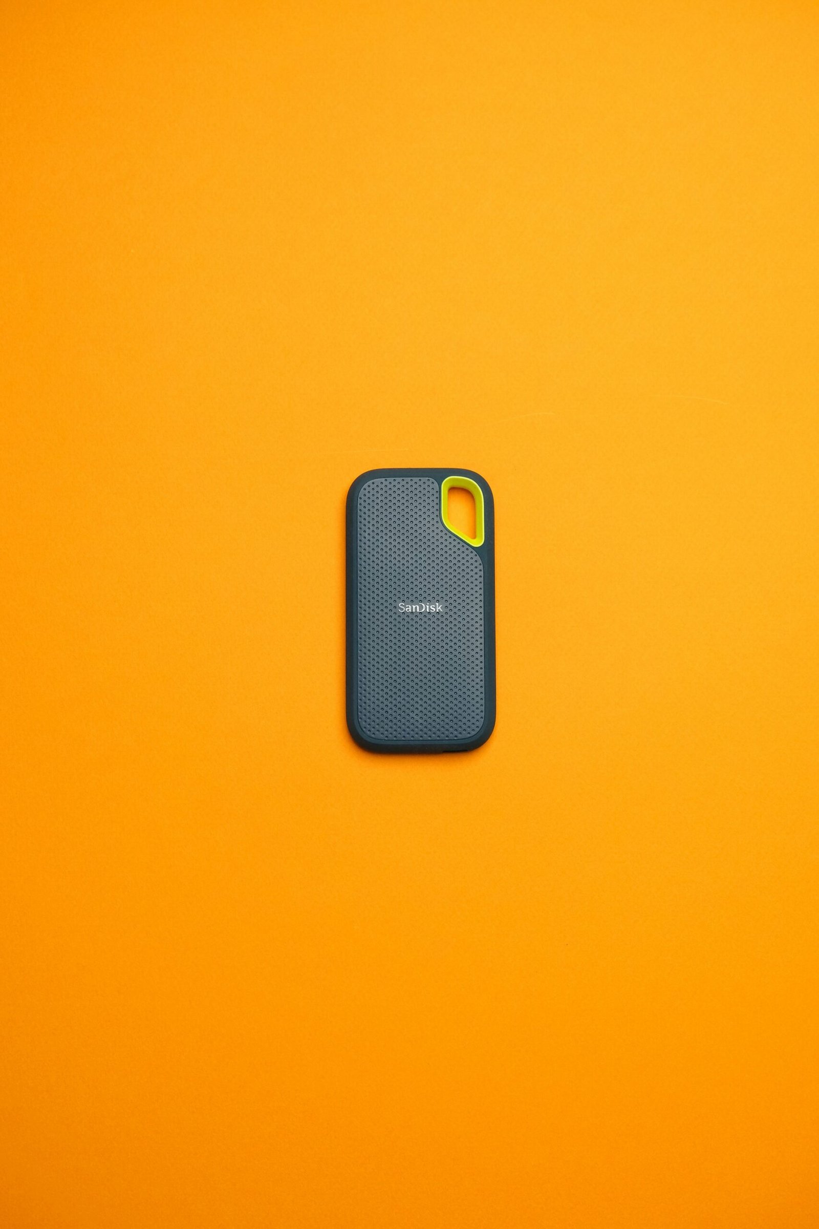 A cell phone sitting on top of a yellow surface